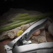 "Garlic being crushed with ergonomic handle tool