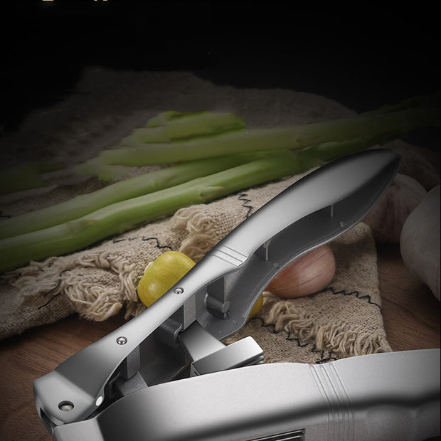 "Garlic being crushed with ergonomic handle tool