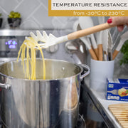 Utensils arranged in a bucket on kitchen counter