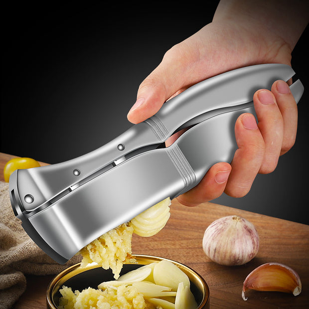 "Manual garlic press crushing garlic in hand"