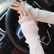Woman wearing beige UV gloves while driving